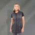 A woman is wearing a lightweight, packable insulated puffer vest in dark grey, featuring a zip front and a high collar.