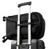 A black backpack attached to a wheeled suitcase, featuring straps for secure fastening and a sleek design.