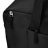 A black duffle bag corner with zippers and webbing straps, featuring a subtle logo on the surface.