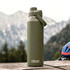 A drink bottle in olive green with a screw-top lid and a handle, featuring a logo. Set against a mountainous background.