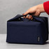 A navy blue cooler bag with a handle, featuring a zipped top and a visible pocket on one side.