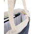 A navy and cream tote bag with a striped interior, featuring straps and an interior pocket for storage.