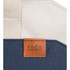 A navy and cream tote bag featuring a leather tag with branding and sturdy woven straps.