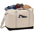 A cream and black cotton canvas duffel bag filled with assorted clothing items and accessories. It has a logo.
