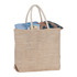A herringbone-patterned jute tote in beige, filled with a blue and patterned fabric, featuring two handles and a logo.