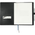 A black refillable leather journal with blank pages, a pocket for cards, and a pen attached.