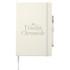 A large, hardbound journal in cream with an elastic closure and a pen holder, featuring a logo.