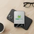 A silver MagSafe wireless power bank resting on a black phone, beside a coffee cup and glasses.