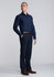 A navy long sleeve shirt is worn by a model, paired with dark trousers and brown shoes. The shirt features a logo.