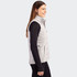 A grey women's hybrid vest is displayed on a model, featuring a zip front and side pockets.