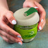 A drink bottle featuring green accents and a light grey lid, with a floral design and branding.