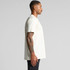 A plain cream Classic Pocket Tee displayed on a model from the side, featuring a logo on the chest.
