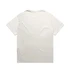 A plain light-coloured heavy faded tee with short sleeves and a relaxed fit, featuring a logo.