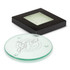 A round glass coaster set in a black box, featuring a logo in grey on the surface.