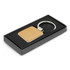 A square wooden key ring with a metal ring, presented in a black gift box with a velvet-like interior.
