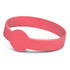 A pink silicone wristband with a circular feature, ideal for exhibitions and events. It has a branding logo.