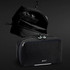 A black Swiss Peak toiletry bag featuring multiple compartments and a hook for hanging. It has a logo on the front.