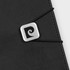 A black notebook featuring a textured cover and an elastic band with a metallic logo.