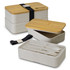 A stackable lunch box in a light beige colour with bamboo lid, featuring cutlery and a strap for secure closure.