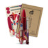 A wooden model of a rocket ship in red and white, alongside a packaging box and assembly parts.
