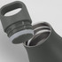A drink bottle in a dark green colour with a silver interior and a removable lid featuring a handle.