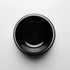 A black pet bowl with a glossy finish and a circular design. It features branding on the exterior.