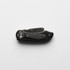 A black and silver utility knife with a folding design and a metallic finish, featuring a logo.