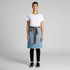 A denim half apron in light blue with a brown tie, worn over a white t-shirt and black pants. Features a logo.