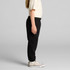 Black track pants for youth, featuring an elastic waistband and side pockets, showcased on a child.