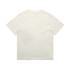 A heavy faded tee in a light cream colour, featuring a simple design and a logo on the label.