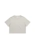 A light beige cropped T-shirt featuring a round neckline and short sleeves, with a logo tag on the inside.