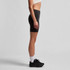 Active bike shorts in black, featuring a fitted design and a high waistband, paired with black trainers.