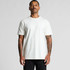 A man wearing a plain white organic t-shirt with short sleeves. The shirt has a logo on it.