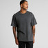 A man wearing a stone wash, heavy grey T-shirt with short sleeves. The shirt has a relaxed fit and a logo.