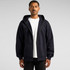 A navy zip-up hoodie with a hood and front pockets, worn by a model. Includes a logo on the garment.