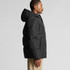 A black hooded puffer jacket with a side view of a person wearing it, featuring a simple design and a logo.