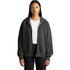 A woman wearing a faded dark grey zip hoodie, featuring a front pocket and a logo.