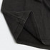 A faded black unisex T-shirt featuring a simple design and a subtle logo on the fabric.