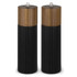 A pair of salt and pepper grinders with wooden tops and ribbed black bases. Each grinder has a silver knob on top.