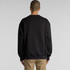 A black jumper with a relaxed fit, featuring a plain back design. The model is facing away from the camera.