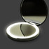 A round, silver compact mirror with an LED light surrounding the edge, opened to reveal a reflective interior.