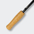 A black fishing rod with a textured cork handle. The rod features a sleek design and a sturdy construction.