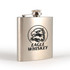 A stainless steel hip flask with a polished finish and an eagle logo on the front.