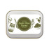 A silver rectangular tin labeled "Lush Olive Farms" featuring illustrations of various bottles and olives.