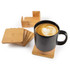 A black mug on a bamboo coaster, surrounded by a set of five additional bamboo coasters.