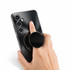 A black phone grip and stand attached to a mobile phone, with a hand demonstrating its use.