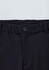 A close-up of black cargo pants featuring a button closure and elastic waistband. Logo present.