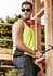 A man wearing a bright yellow hi-vis singlet and sunglasses, holding a hammer, with a construction backdrop.