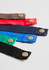 A selection of Urban Bib Straps in red, blue, green, black, and brown, featuring brass snaps.