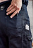 Navy cargo pants featuring multiple pockets, including a phone holder and a pocket for tools. Includes a branding logo.